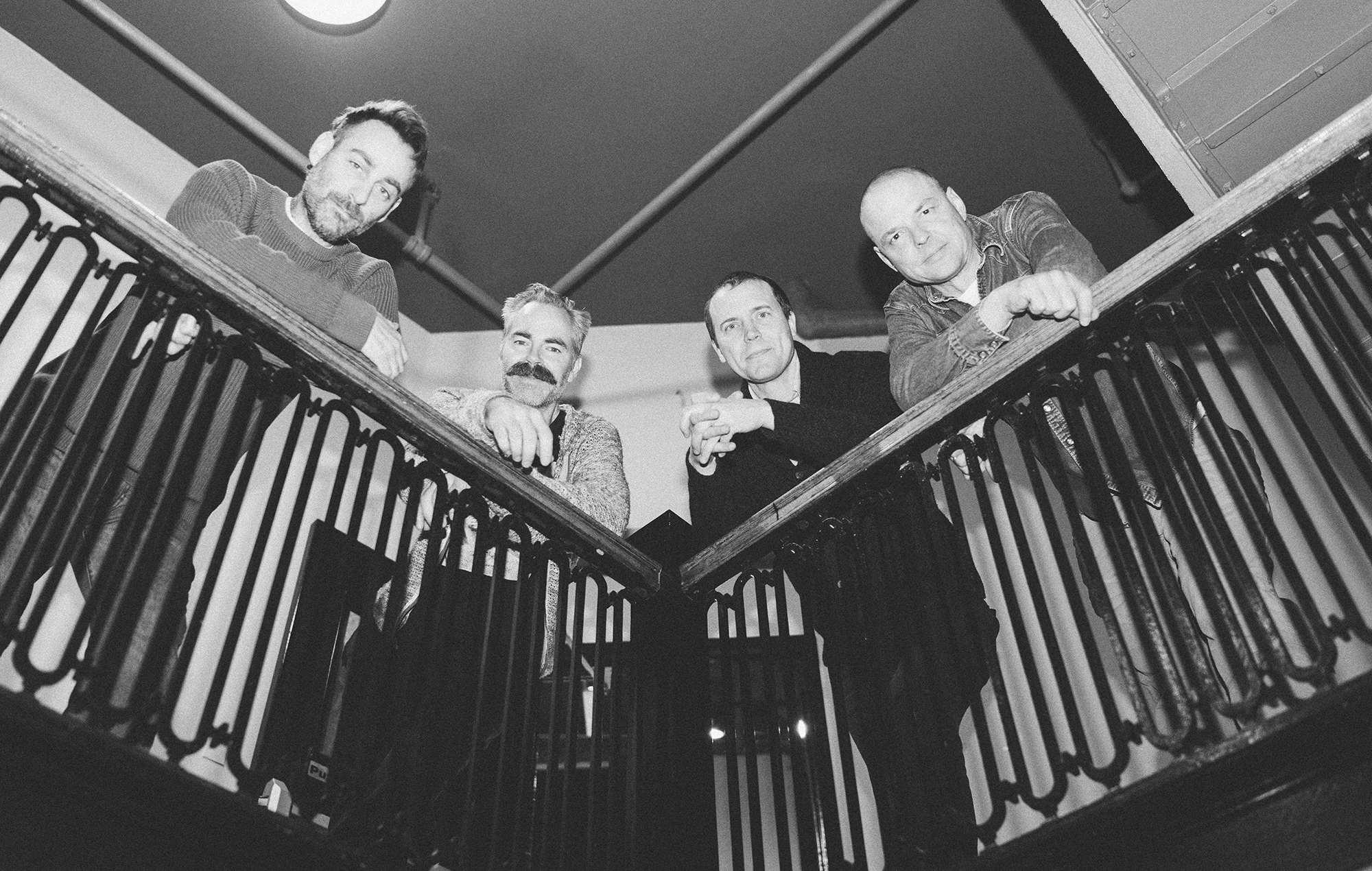 American Football photographed against a railing in black and white, photo by Alexa Viscius