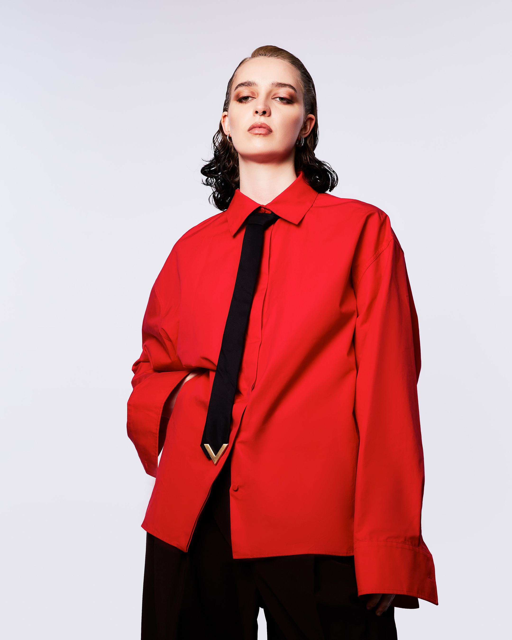 Gia Ford in a red jacket and black tie, photo by Melanie Lehmann